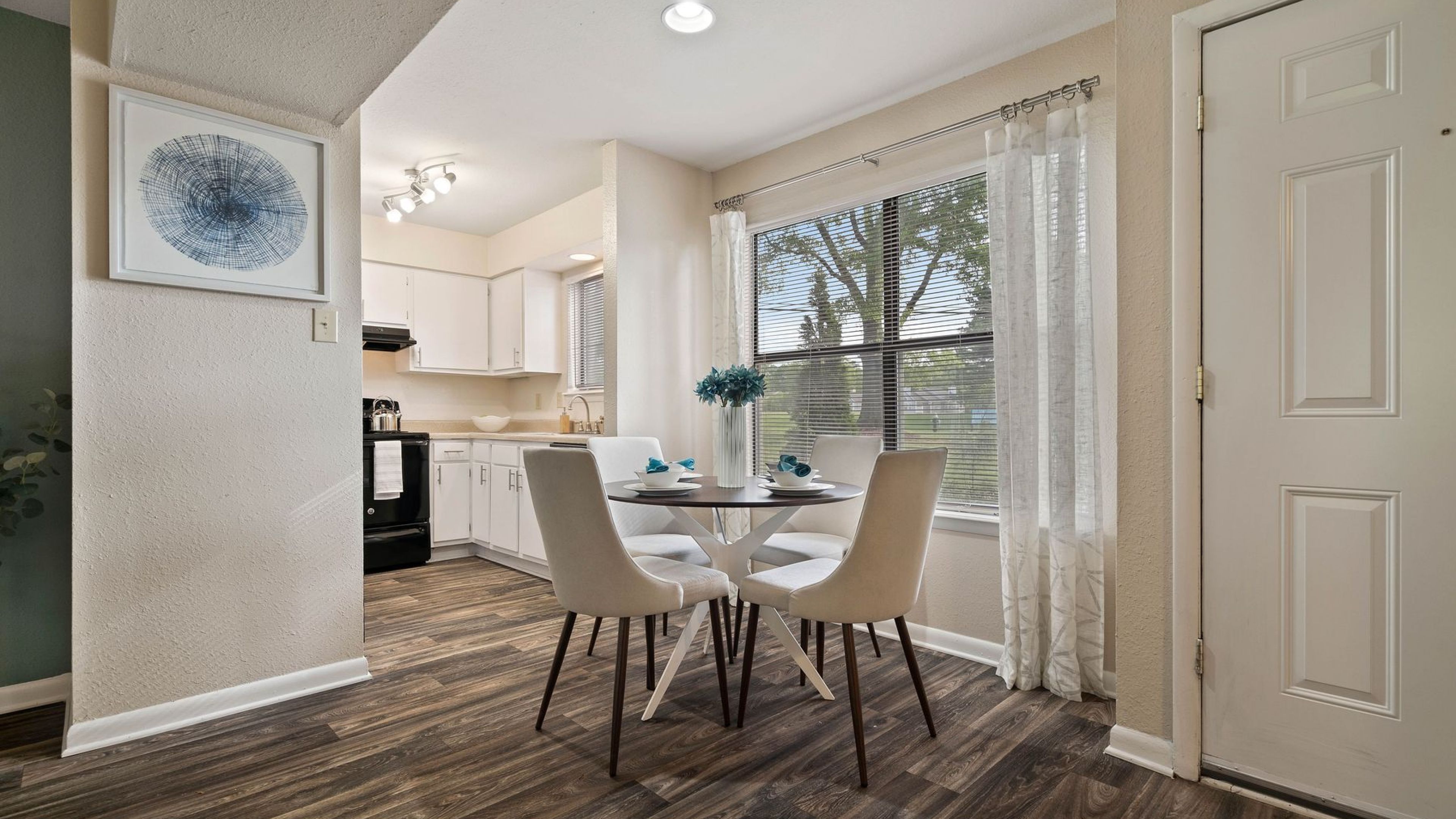 Hawthorne at Oak Ridge apartment living space and kitchen with small dining table and appliances